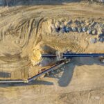 Aerial view of a construction site in Rochester, showcasing dirt excavation and heavy machinery.