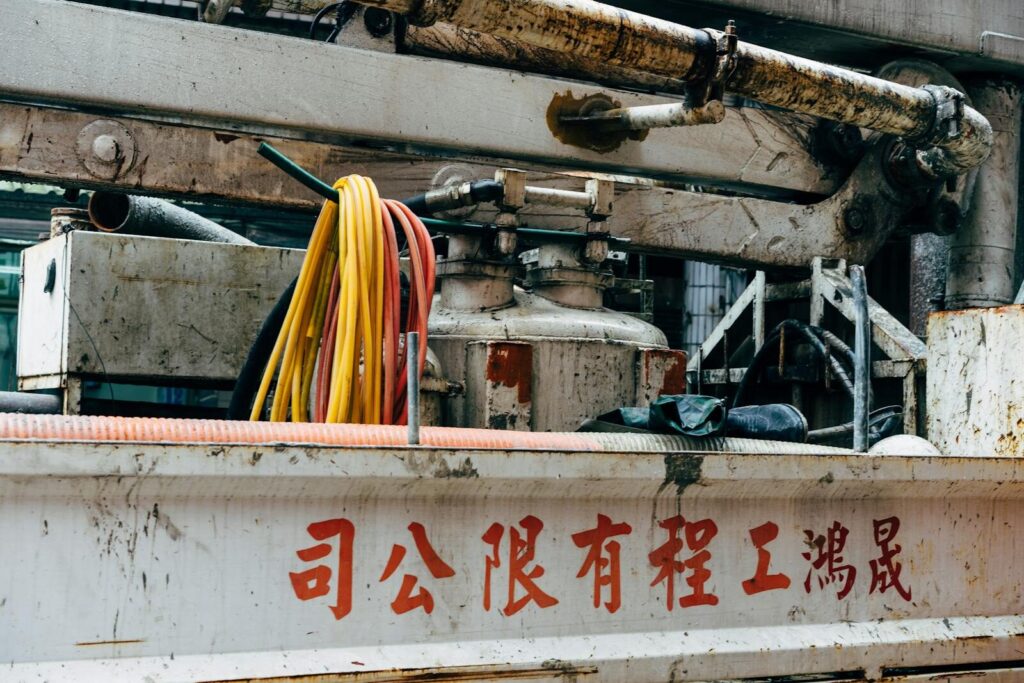 Close-up of aged industrial machinery with color-coded cables in Taipei.